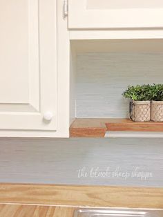 the kitchen counter is clean and ready to be used as a shelf for pots or planters