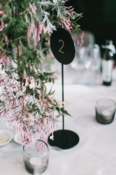 the table is set with glasses, plates and place cards for guests to sit at