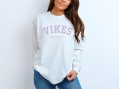 Support your team in style with our Minnesota Vikings Unisex Long Sleeve T-Shirt, crafted from 100% ring-spun cotton for ultimate comfort and durability. Whether you're cheering from the stands or watching from home, this shirt is perfect for showing off your Vikings pride. The soft, breathable fabric ensures a great fit for every fan, making it an essential addition to your game day wardrobe.  Get your Minnesota Vikings long sleeve t-shirt today and join the Skol nation in true comfort and styl Pre-shrunk Long Sleeve Shirt, Pre-shrunk Long Sleeve Shirt For College, White Long Sleeve School Spirit Shirt, White Long Sleeve Shirt For School Spirit, Football Vikings, Vikings Shirt, Mn Vikings, Viking Shirt, Vikings Football