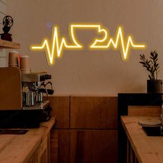 a neon sign with the word coffee on it in front of a wooden counter top