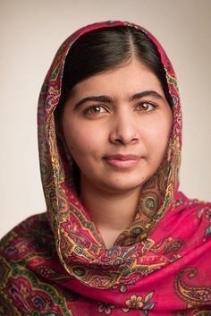 a woman wearing a red shawl looking at the camera