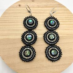 Dangle Black beaded earrings with Abalone Cabochons, seed bead earrings Customized and designed exclusively by me.  Measurement: 4 inches *1 inches Materials: seed beads, backing faux leather. The earrings will be ready for shipment within 3-5 days! Very often however I manage to have them ready for shipment in a much shorter time! MORE EARRINGS HERE: https://dodojewelrydesign.etsy.com Why order from Dodojewelrydesign? Meaningful and timeless jewelry that you can wear every day. -with an average Abalone Beaded Earrings, Beaded Regalia, Indigenous Beaded Earrings, Dodo Jewelry, Indigenous Beading, Indigenous Crafts, Earring Inspired, Black Beaded Earrings, Jingle Dress