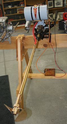 a machine that is sitting on top of a wooden table in a room filled with tools