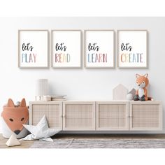 three framed posters on the wall above a dresser in a child's room with toys