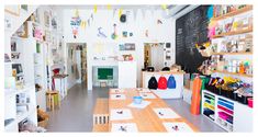 the inside of a children's playroom with lots of toys and books on shelves