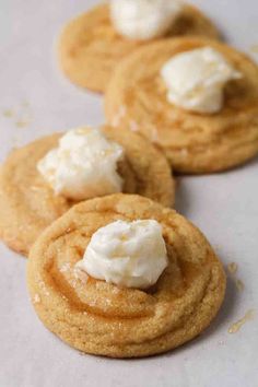 three cookies with whipped cream on top