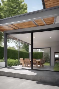 Modern patio with wooden dining table and chairs under a partially covered roof, surrounded by greenery. Porch Extension