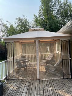 a gazebo sitting on top of a wooden deck