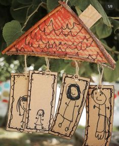 three little tags hanging from a tree with some drawings on them and one has a house