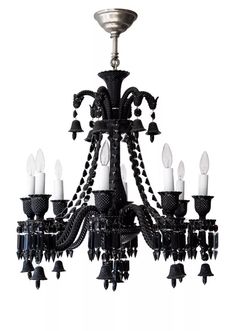 a black chandelier with white candles hanging from it