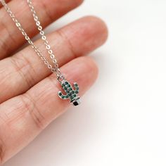 "Beautiful tiny cactus necklace made of green CZ stone silver color cactus charm with rhodium plated brass chain. Cute size charm necklace is great for gift or yourself. Your necklace will ship in a  gift box.    ♥ Cactus charm 1/4\" x 3/8\"  ♥ Chain length 14\"-18\"  ♥ Rhodium plated over brass / Cubic Zirconia  ♥  See more Rudiana Accessories  Rudiana.etsy.com" Minimalist Silver Charm Necklace With Emerald, Dainty Green Sterling Silver Charm Necklace, Green Sterling Silver Charm Necklace With Lobster Clasp, Green Sterling Silver Necklaces With Charms, Dainty Silver Charm Necklace For May Birthstone, Green Sterling Silver Necklace With Charms, Adjustable Silver Charm Necklace For May Birthstone, Adjustable Green Sterling Silver Charm Necklace, Color Cactus