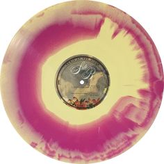 a pink and yellow disc with an image of a bird on the disc's center