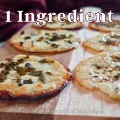 four small pizzas on a wooden board with text overlaying it that reads, 1 ingredient