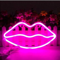 a neon sign with a pink lip in the shape of a woman's mouth