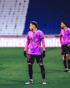 two soccer players are standing on the field