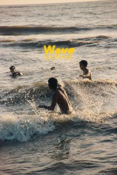 two young men riding surfboards on top of waves in the ocean with yellow marker