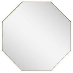 an octagonal mirror with a gold frame in the shape of a hexagonal octagon