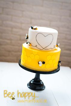 a yellow and white cake sitting on top of a table