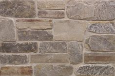 a stone wall that is made out of various types of stones