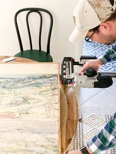 a man working on a piece of art with a driller and circular sawhorse