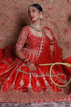 Red lehenga with embroidery in zardozi, cutdana and pearls. Comes with embroidered blouse and net and sheer dupattas.
Component: 4
Pattern: Embroidered
Type Of Work: Zardozi Floral Motifs
Neckline: Square
Sleeve Type: Half
Fabric: Raw Silk, Net
Color: Red
Other Details: 
Floral embroidered blouse
Back tassel tie-up
Occasion: Bride - Aza Fashions Navratri Gown With Cutdana For Traditional Ceremonies, Red Anarkali Gown For Traditional Ceremonies, Resham Embroidery Lehenga For Traditional Ceremonies, Traditional Red Semi-stitched Gown, Festive Kundan Lehenga With Cutdana Details, Festive Kundan Lehenga With Cutdana, Red Dola Silk Lehenga For Eid, Red Chandbali Lehenga For Eid, Traditional Red Gown