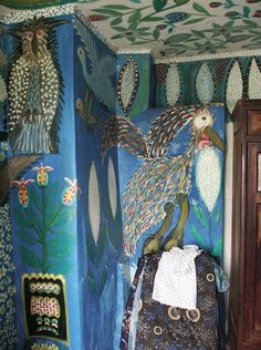 an artisticly decorated room with peacocks on the walls