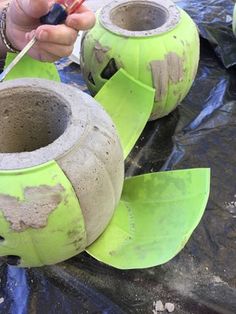 a person is painting the inside of two vases