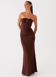 Peppermayo Exclusive Introducing the Rudy Maxi Dress. With its strapless neckline and captivating hardware detailing at the front, this dress exudes sophistication and charm.   - Maxi length- Strapless neckline- Stretch material- Fully lined- Ruched detail- Bust keyhole cut out with hardware detail- Material: 95% Polye Brown Dresses Formal, Brown Maxi Dress, Rush Outfits, Formal Dresses Graduation, Audrey Dress, Silk Satin Dress, Brown Dresses, Strapless Neckline, Long Sleeve Knit Dress