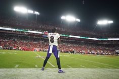 a football player stands on the field in front of an empty stadium during a game