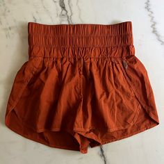 Brand: Fp Movement By Free People Style: The Way Home Shorts Color: Rust Size: Medium Condition: Brand New Without Tags Orange Shorts With Elastic Waistband, Orange Cotton Shorts With Elastic Waistband, Yoga Shorts With Waistband For Summer, Orange Beach Shorts With Elastic Waistband, Orange Beach Bottoms With Elastic Waistband, Orange Vacation Shorts With Elastic Waistband, Summer Orange Shorts With Built-in Shorts, Orange Bottoms With Built-in Shorts For Vacation, Orange Stretch Shorts With Elastic Waistband