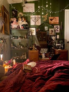 a bedroom with green walls and pictures on the wall