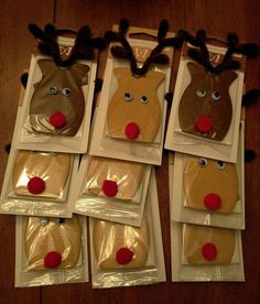 six reindeer masks in plastic bags on a wooden table with red noses and nose rings