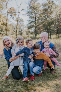 a family posing for a photo in the grass