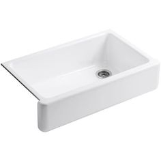 a white sink sitting on top of a counter