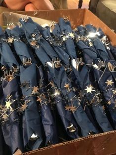 a box filled with lots of blue cloth and gold stars on top of each other