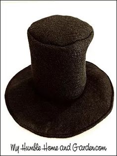 a black top hat sitting on top of a white table