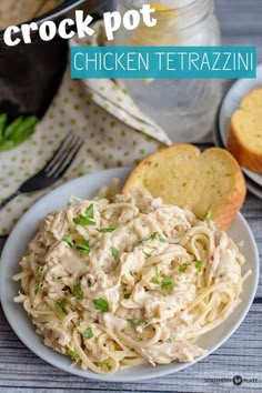 chicken tetrazzini in a white bowl with bread and parsley on the side