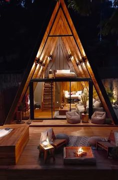 a house that is made out of wood and has lights on the inside of it