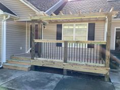 a house with a wooden porch and railing