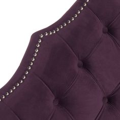 an upholstered headboard with studding and buttons on the back of it