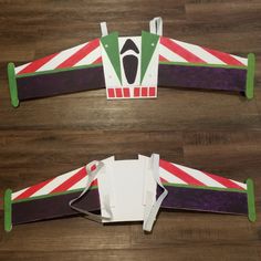 two pieces of paper cut out to look like an airplane with stripes on the wings