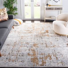 a living room area with couches, chairs and rugs