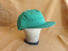 Nice vintage insulated winter hat by K-Products, solid green color with internal adjustable strap. In new condition, original tags attached, never used. Good deep XL fit up to 23.5 inches, can be adjusted with internal hidden snap back strap. Please ask any questions before purchasing, especially concerning fit or condition. All items are vintage and in condition as described. Shipping via USPS unless otherwise agreed upon.  All sales final, no returns - Thank You from Big Weekend! Ear Flap Hats, Solid Green, Snap Backs, Winter Hat, Kelly Green, Back Strap, Trucker Hats, Green Color, Caps Hats