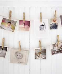 several pictures hanging on clothes pins with photos pinned to the clothesline and pegs