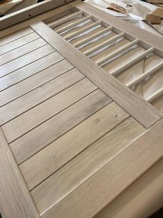 an unfinished bed frame with wooden slats