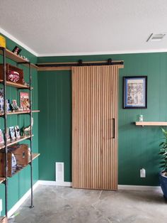 a room with green walls and wooden doors