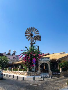 a windmill on top of a building next to a parking lot