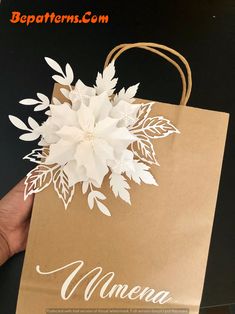 a person holding a brown paper bag with white flowers on it and the words minnesota printed on it