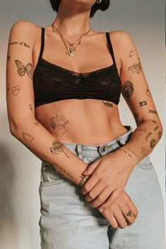 a woman with tattoos on her arm and chest