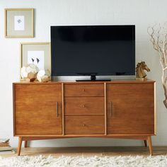 a large television sitting on top of a wooden cabinet